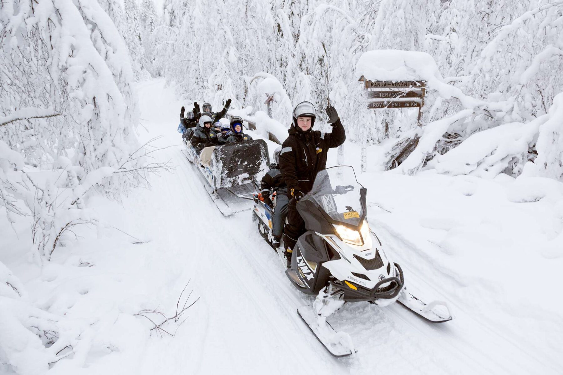 finnish lapland ranua snowmobiling with children on sled