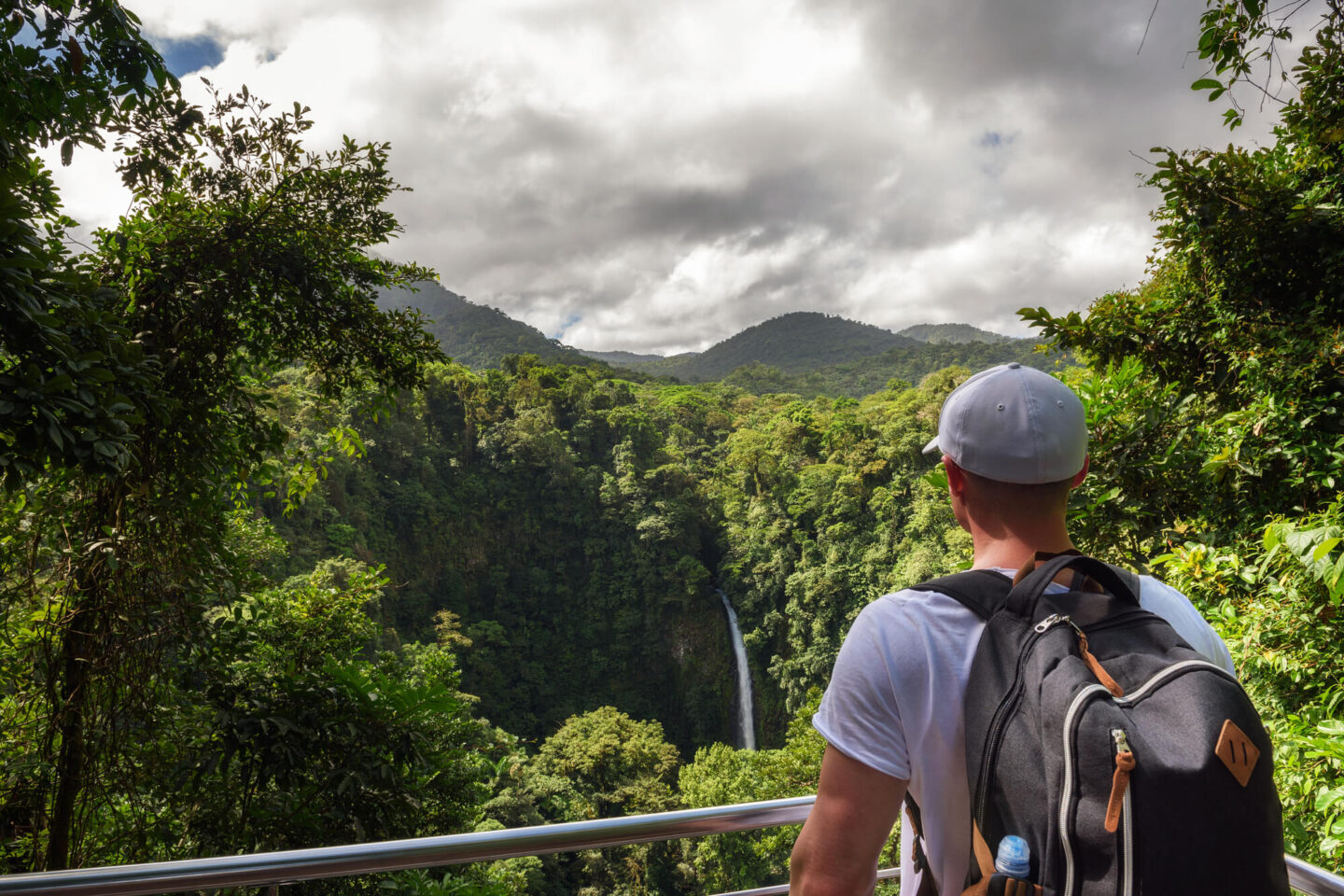 costa-rica-tourist-looking-at-la-fortuna-waterfall-astk