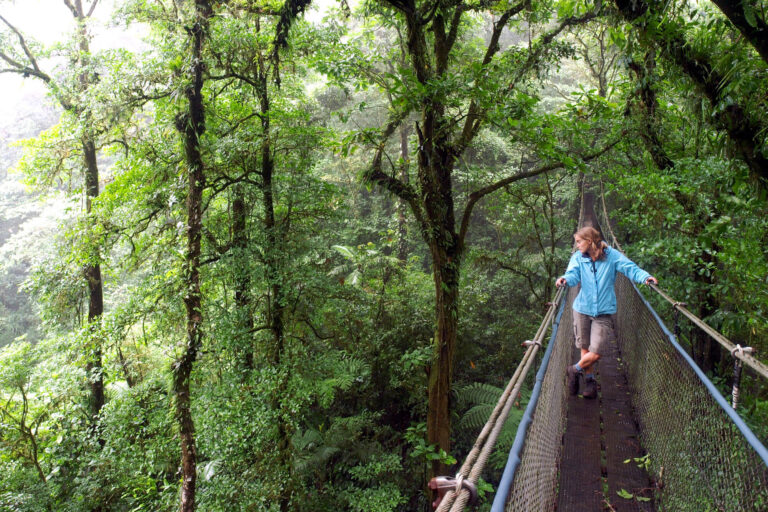 costa-rica-woman-on-hanging-bridge-monteverde-cloudforest-istk