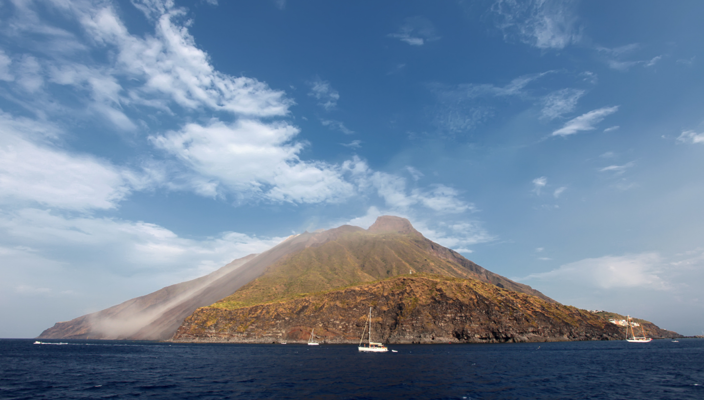 Picture of stromboli volcano in Italy surrounded by the sea