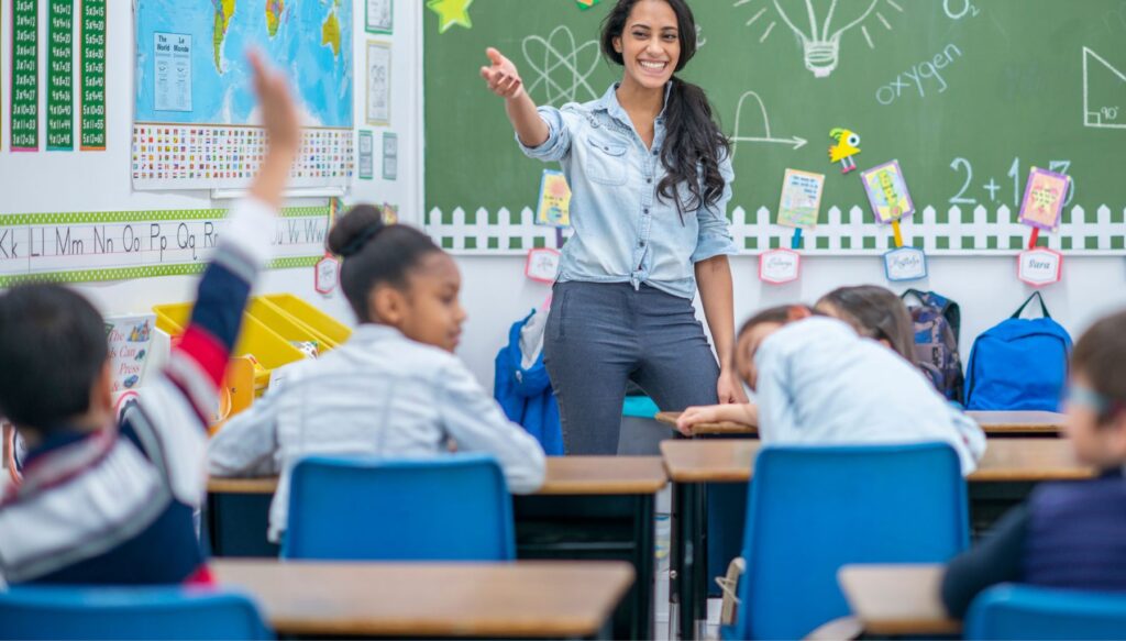 Picture of teacher pointing at a students in a classroom