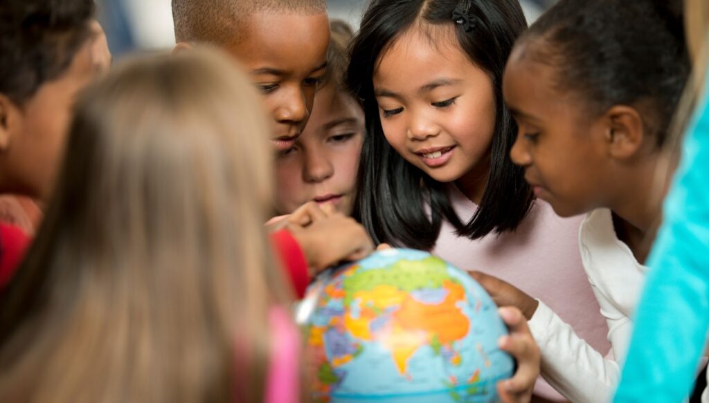 Pictures of children looking at a globe in a classroom