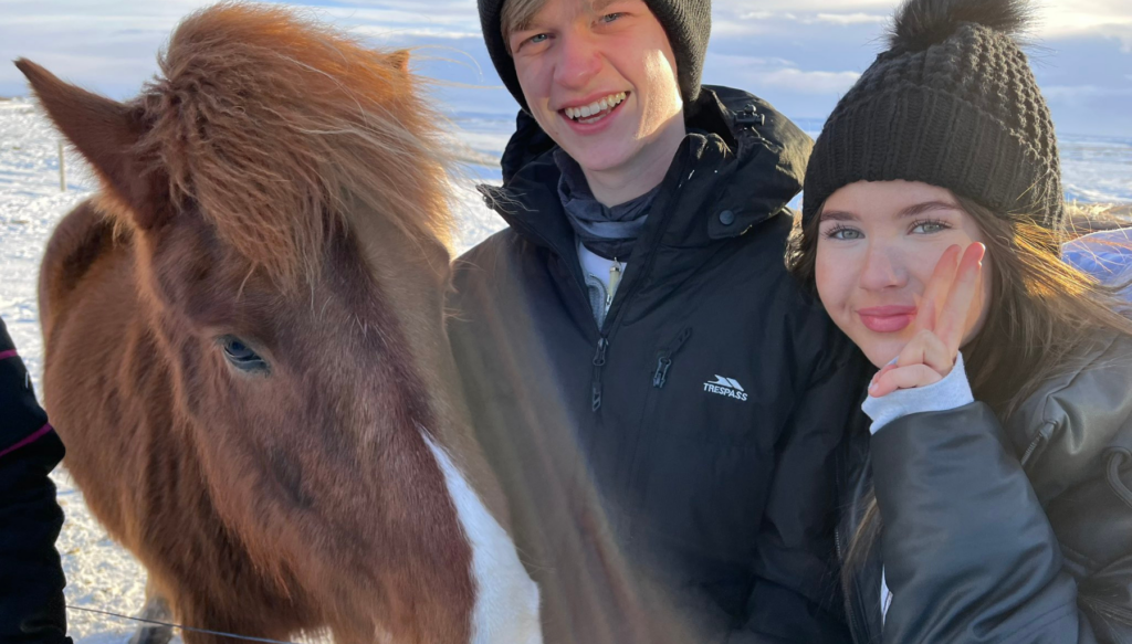 Picture of school students with wild icelandic horse during trip to Iceland