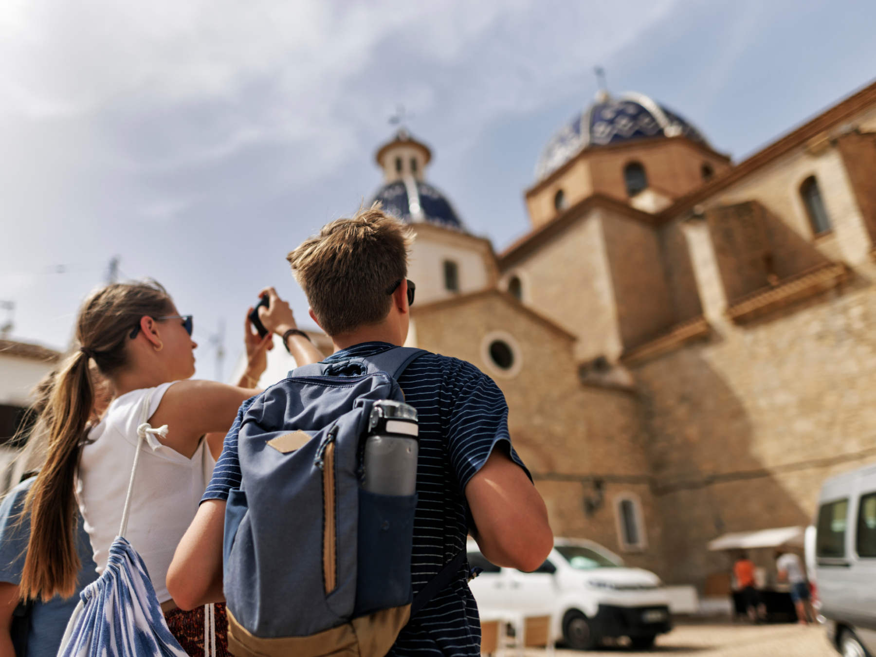 Picture of a girl and a boy looking up at a castle and taking a picture