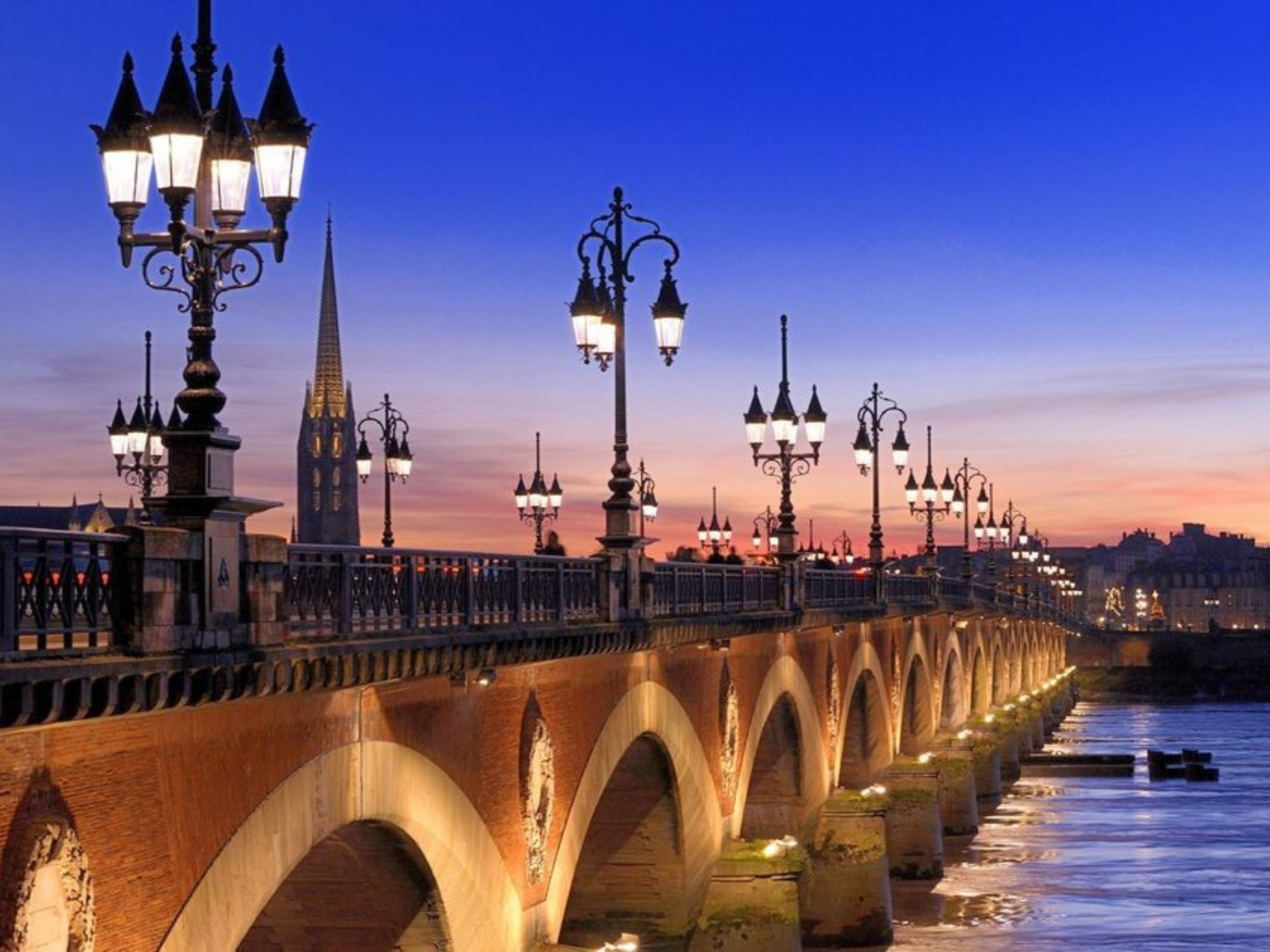 Picture of bridge in Bordeaux at sunset with street lights lit up